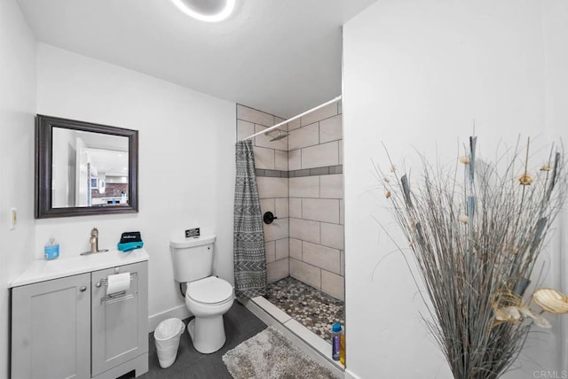 bathroom with vanity, tile patterned flooring, toilet, and walk in shower