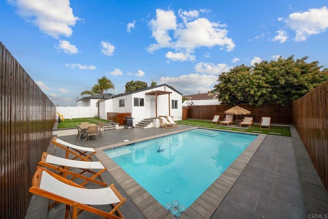 view of swimming pool featuring a patio and an outdoor structure