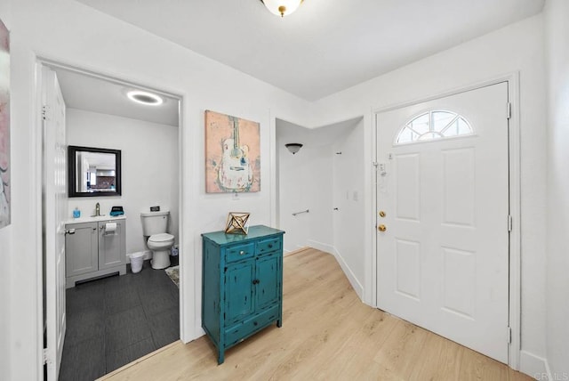 entryway featuring light wood-type flooring and sink