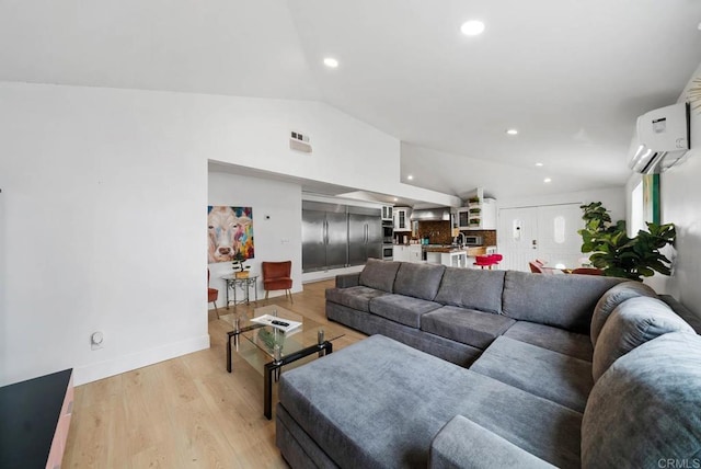 living room with a wall unit AC, lofted ceiling, and light hardwood / wood-style flooring