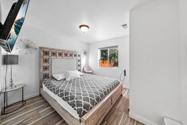 bedroom with hardwood / wood-style flooring