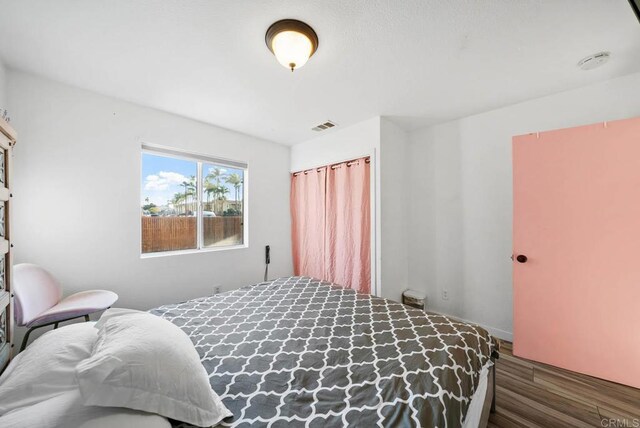 bedroom featuring dark hardwood / wood-style flooring