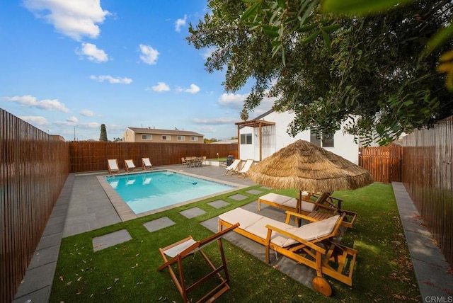 view of pool featuring a patio and a lawn