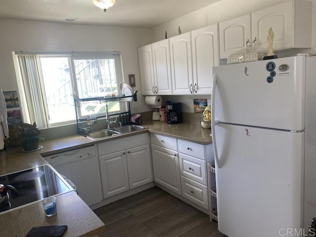 kitchen featuring sink, white appliances, white cabinetry, and dark wood-type flooring