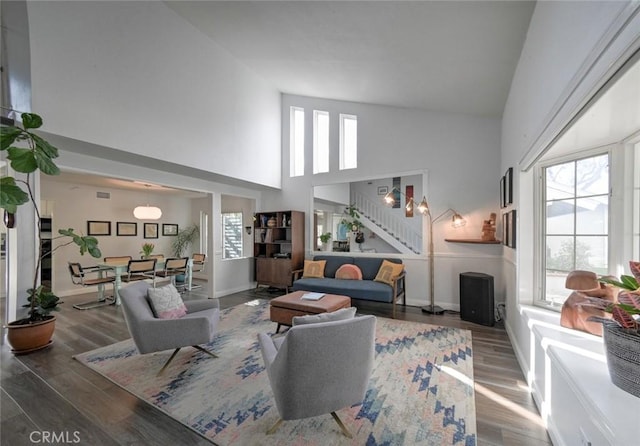 living room featuring hardwood / wood-style flooring and high vaulted ceiling