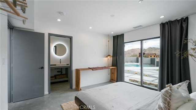 8750 Desert Shadows, Joshua Tree, CA 92252 - bedroom featuring concrete floors, access to exterior, recessed lighting, ensuite bathroom, and a sink