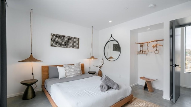 8750 Desert Shadows, Joshua Tree, CA 92252 - bedroom with finished concrete floors, recessed lighting, and baseboards