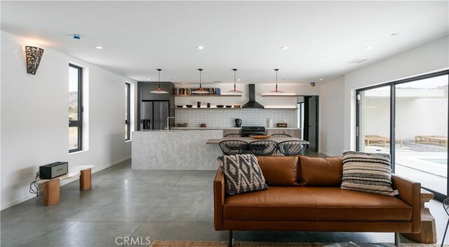 8750 Desert Shadows, Joshua Tree, CA 92252 - living room featuring finished concrete floors, recessed lighting, and baseboards
