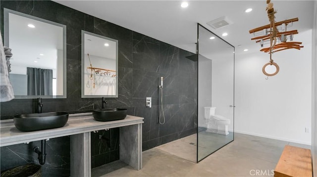 8750 Desert Shadows, Joshua Tree, CA 92252 - bathroom featuring a walk in shower, finished concrete floors, double vanity, backsplash, and recessed lighting