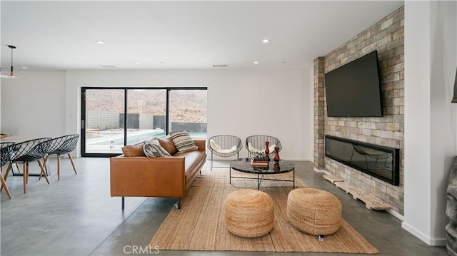 8750 Desert Shadows, Joshua Tree, CA 92252 - living area featuring finished concrete floors, a brick fireplace, recessed lighting, and baseboards