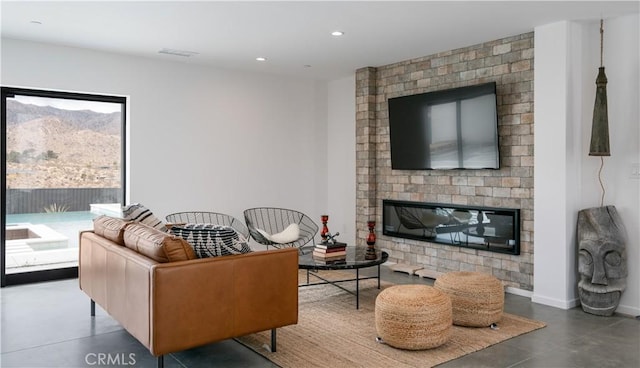8750 Desert Shadows, Joshua Tree, CA 92252 - living area with a brick fireplace, recessed lighting, a mountain view, finished concrete floors, and baseboards