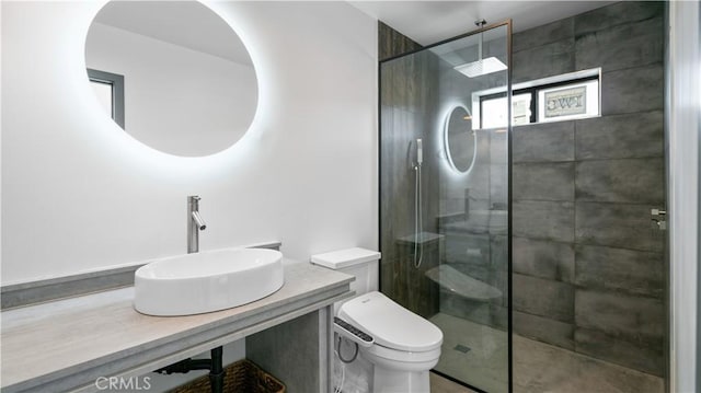 8750 Desert Shadows, Joshua Tree, CA 92252 - bathroom featuring toilet, a tile shower, and vanity