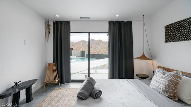 8750 Desert Shadows, Joshua Tree, CA 92252 - bedroom featuring access to exterior, a mountain view, finished concrete floors, and recessed lighting