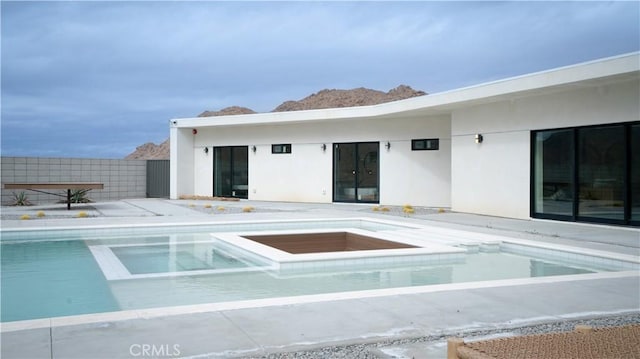 8750 Desert Shadows, Joshua Tree, CA 92252 - back of house featuring an outdoor pool, stucco siding, a patio, and an in-ground hot tub