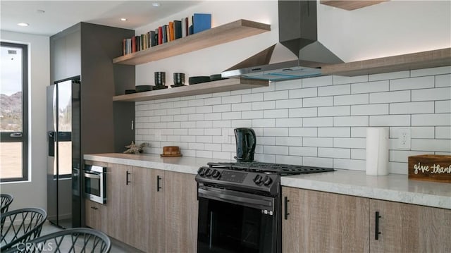 8750 Desert Shadows, Joshua Tree, CA 92252 - kitchen featuring black range with gas stovetop, extractor fan, refrigerator with ice dispenser, open shelves, and backsplash
