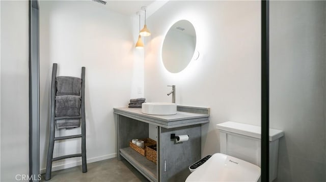 8750 Desert Shadows, Joshua Tree, CA 92252 - bathroom featuring a sink, toilet, and concrete flooring