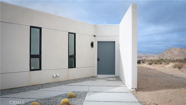 8750 Desert Shadows, Joshua Tree, CA 92252 - entrance to property with stucco siding and a mountain view