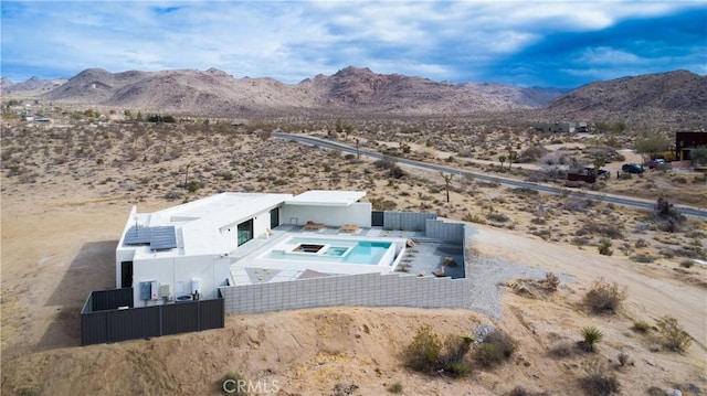 8750 Desert Shadows, Joshua Tree, CA 92252 - aerial view of property and surrounding area featuring a desert landscape, a mountain backdrop, and a pool