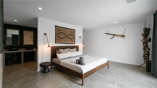 8750 Desert Shadows, Joshua Tree, CA 92252 - bedroom featuring recessed lighting, a sink, ensuite bathroom, and baseboards