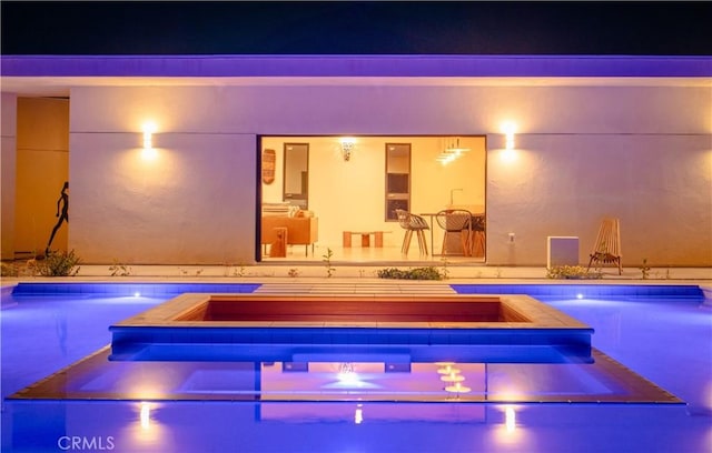 8750 Desert Shadows, Joshua Tree, CA 92252 - pool at night featuring a pool with connected hot tub