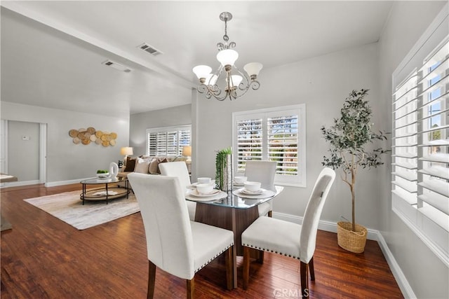 dining space featuring a notable chandelier and dark wood-type flooring