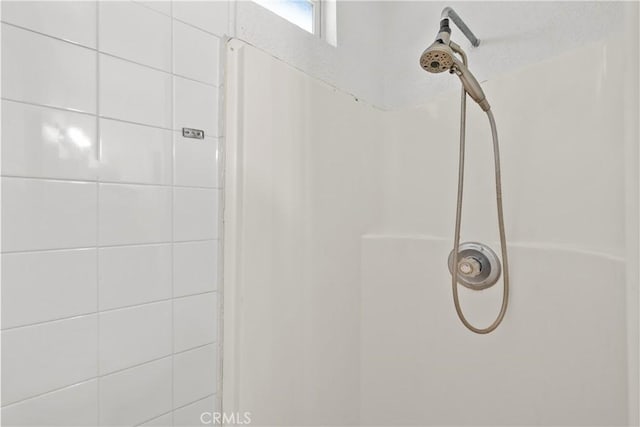 bathroom with a tile shower