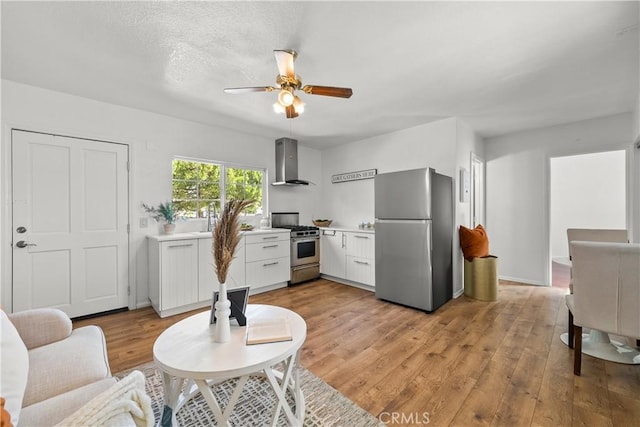 living room featuring ceiling fan and light hardwood / wood-style floors