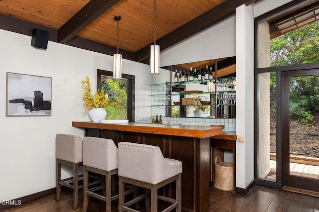 bar with pendant lighting, butcher block counters, vaulted ceiling with beams, and dark hardwood / wood-style floors