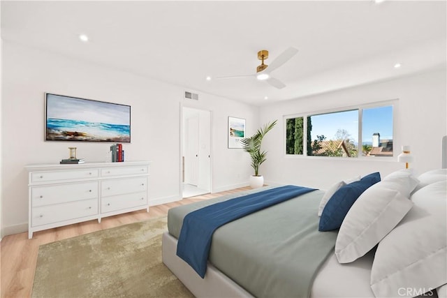 bedroom with ceiling fan and light hardwood / wood-style flooring