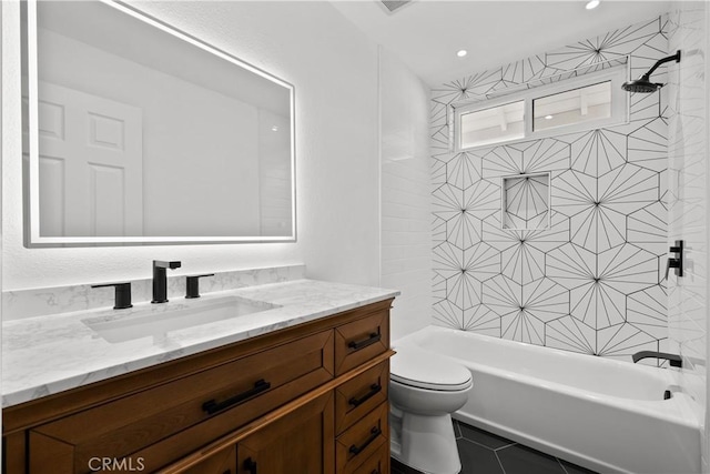 full bathroom with tiled shower / bath combo, toilet, tile patterned floors, and vanity