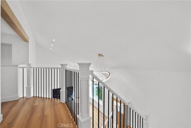 hall featuring hardwood / wood-style flooring and a notable chandelier