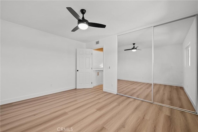 unfurnished bedroom featuring light wood-type flooring, a closet, and ceiling fan