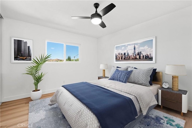 bedroom featuring hardwood / wood-style floors and ceiling fan