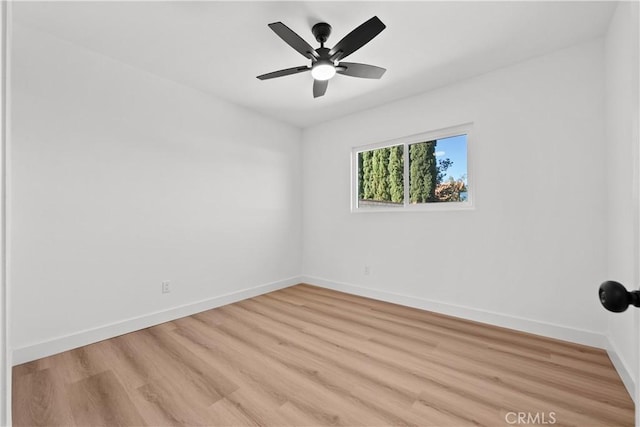 empty room with ceiling fan and light hardwood / wood-style flooring