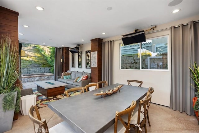 dining room featuring plenty of natural light, concrete flooring, and recessed lighting