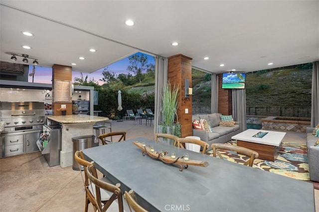 dining area featuring concrete flooring and recessed lighting