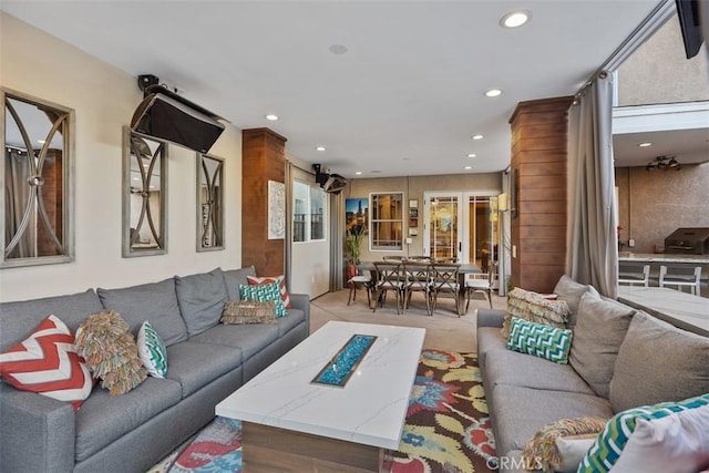 living area featuring recessed lighting and light carpet