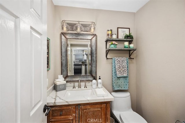 half bathroom with toilet and vanity