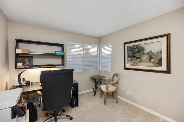 office area featuring light colored carpet and baseboards