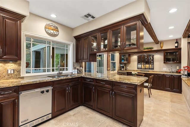 kitchen with visible vents, dishwasher, glass insert cabinets, a peninsula, and a sink