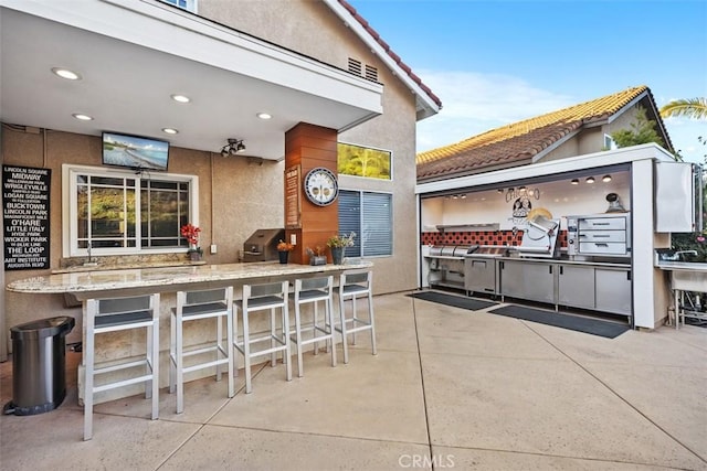 view of patio with a bar and visible vents