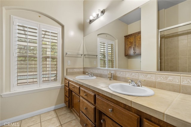 bathroom with tile patterned flooring, tasteful backsplash, and vanity