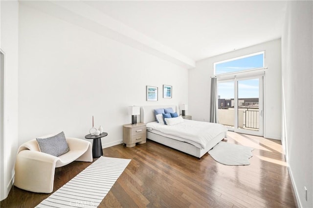 bedroom featuring baseboards, access to outside, and wood finished floors