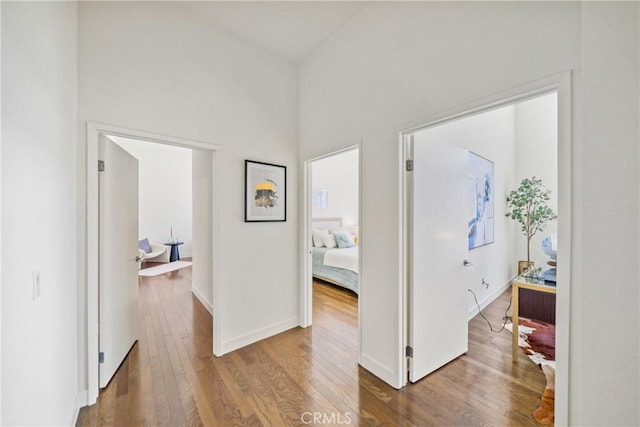 hall featuring baseboards and wood finished floors