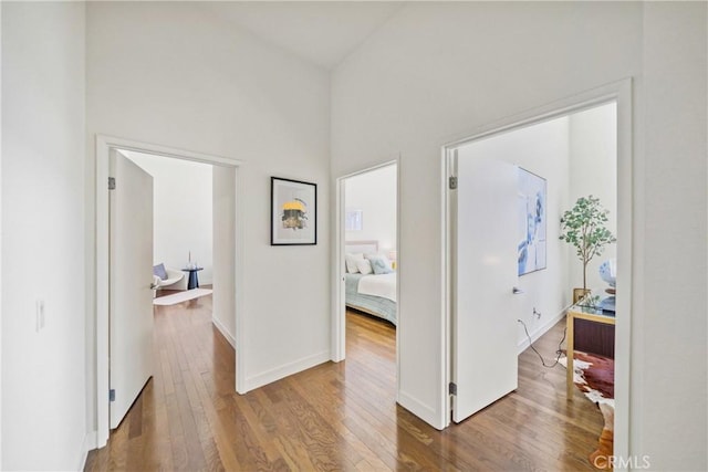 hall featuring baseboards and wood finished floors