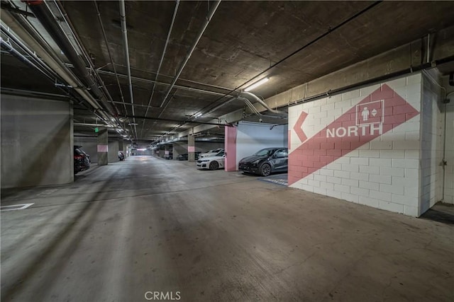 parking garage featuring concrete block wall