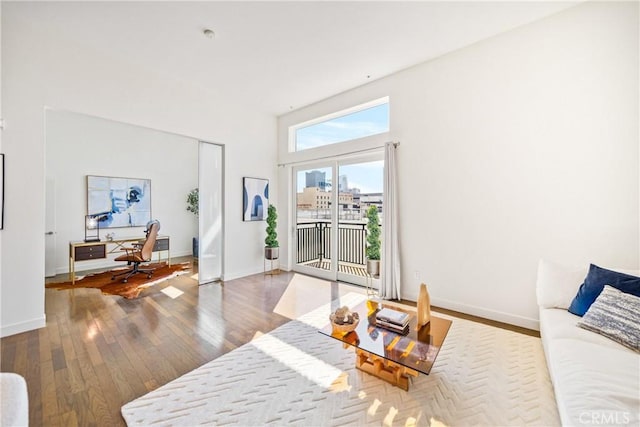 living room with a view of city, wood-type flooring, and baseboards