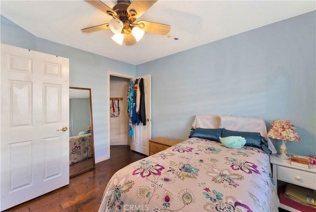 bedroom featuring baseboards, a ceiling fan, and dark wood-type flooring