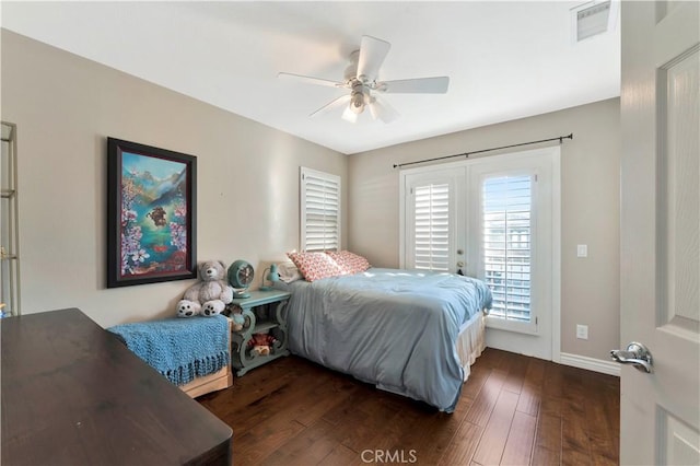 bedroom featuring access to outside, visible vents, dark wood finished floors, and a ceiling fan