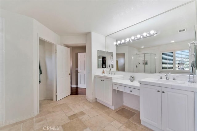 bathroom featuring visible vents, a sink, a shower stall, and double vanity